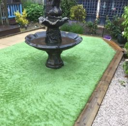 Astro Turf (artificial grass) with sleeper boarders and a water feature, Nottingham: Click Here To View Larger Image