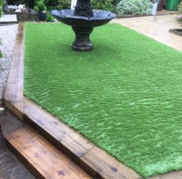 Astro Turf (artificial grass) with sleeper boarders and a water feature, Nottingham: Click Here To View Larger Image